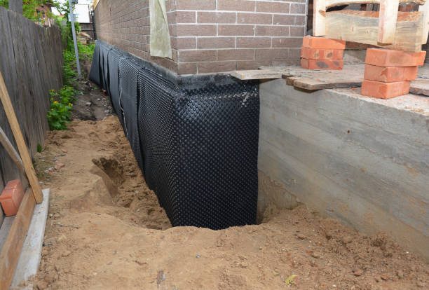 Happy homeowners after waterproofing job in Logan